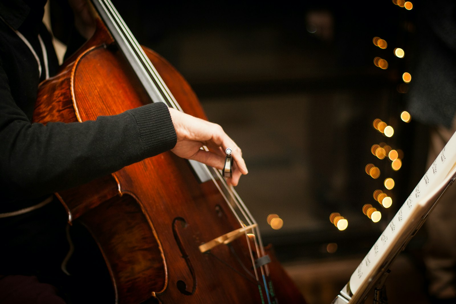 A cellist performing by candlelight